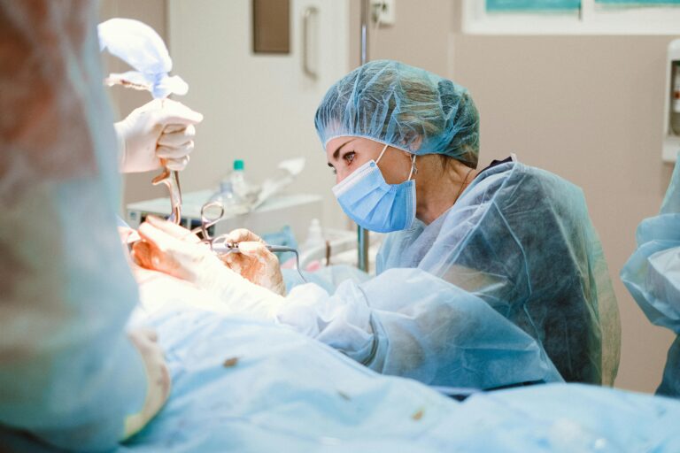 Female surgeon focused on a complex procedure in a sterile operating room, embodying healthcare professionalism.